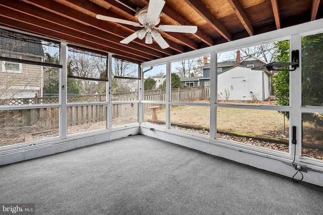 unfurnished sunroom featuring ceiling fan