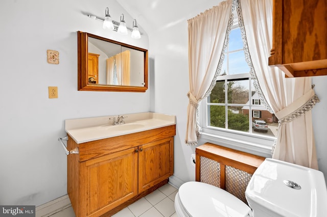 bathroom with tile patterned flooring, vanity, and toilet