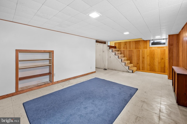 basement with built in shelves and wooden walls