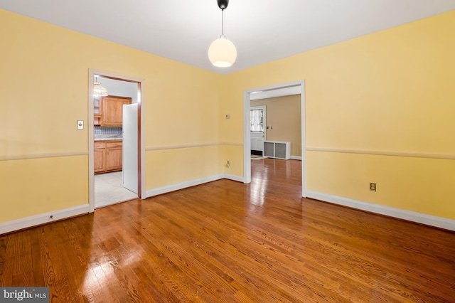 unfurnished room with hardwood / wood-style flooring