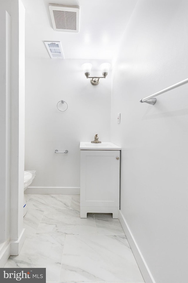 bathroom featuring marble finish floor, baseboards, and visible vents