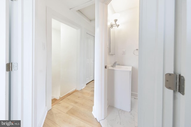 bathroom with wood finished floors and vanity