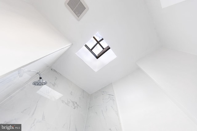 details with a skylight, visible vents, and walk in shower