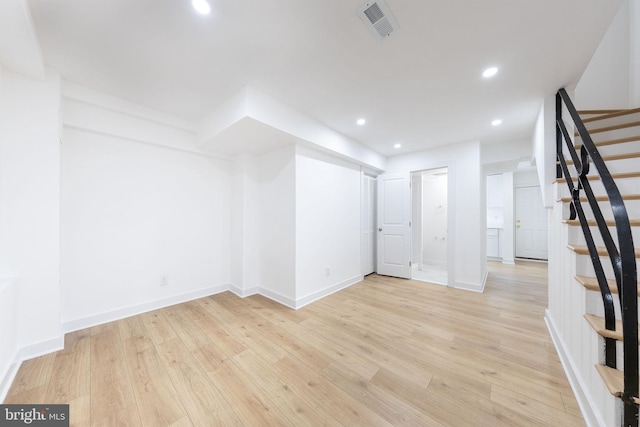 unfurnished room featuring light wood finished floors, baseboards, visible vents, stairs, and recessed lighting