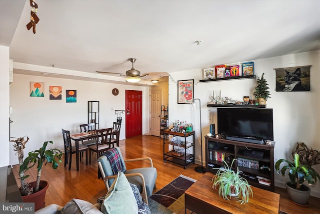 living room with hardwood / wood-style floors and ceiling fan