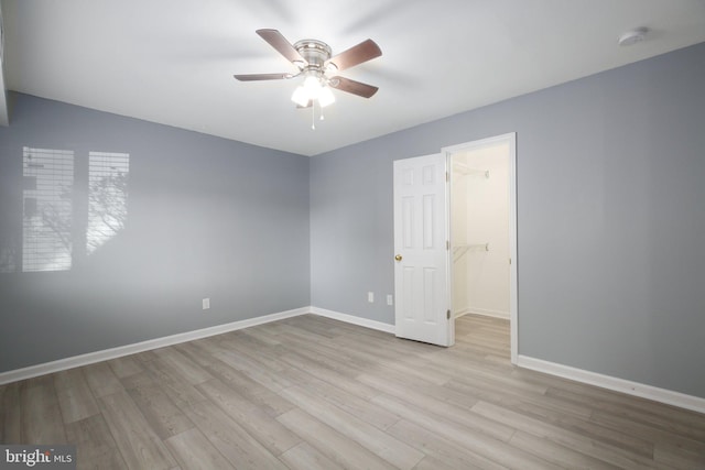 empty room featuring ceiling fan and light hardwood / wood-style flooring