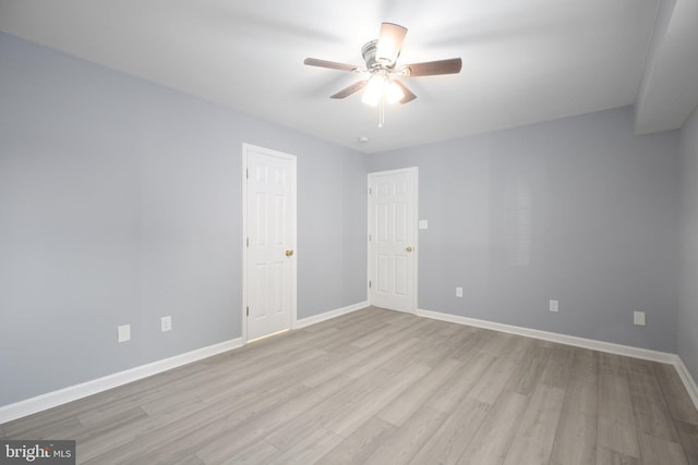 empty room featuring ceiling fan and light hardwood / wood-style flooring