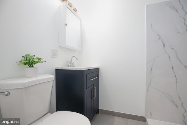 bathroom with vanity, toilet, and tile patterned flooring