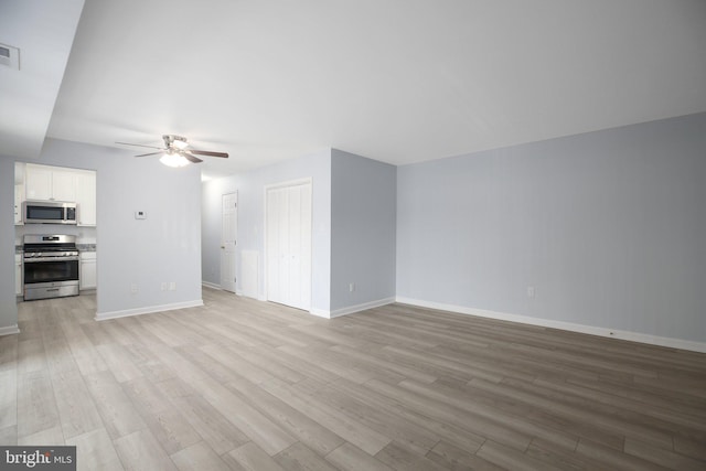 unfurnished living room with ceiling fan and light hardwood / wood-style floors