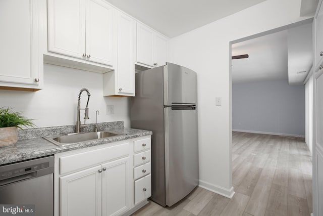 kitchen with white cabinetry, appliances with stainless steel finishes, and sink