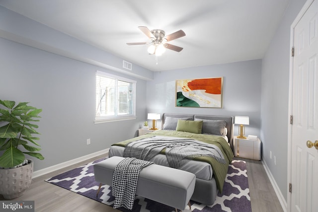 bedroom with light hardwood / wood-style floors and ceiling fan