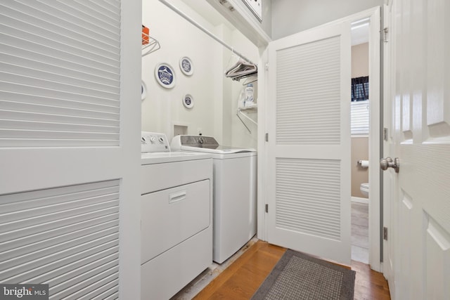 washroom with hardwood / wood-style floors and independent washer and dryer