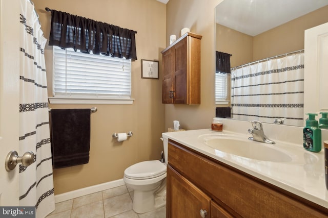 bathroom featuring vanity, tile patterned floors, and toilet