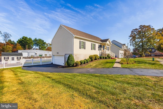 view of front facade with a garage and a front lawn