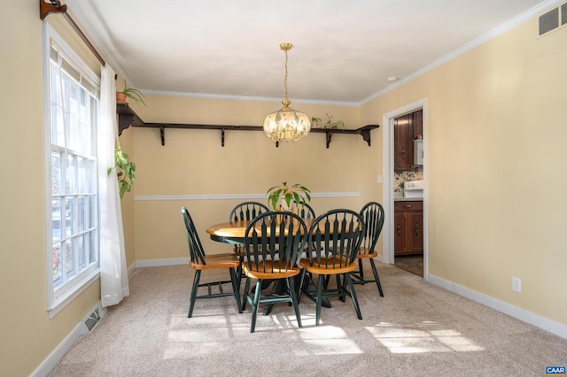 carpeted dining room with crown molding and a notable chandelier