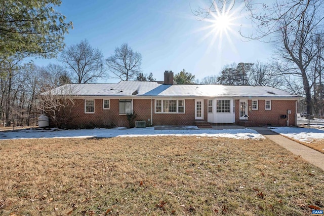 view of front of property with a front yard and central air condition unit