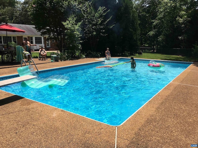 view of swimming pool featuring a patio area