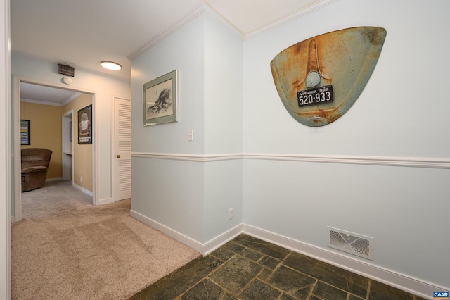 corridor featuring ornamental molding and dark colored carpet