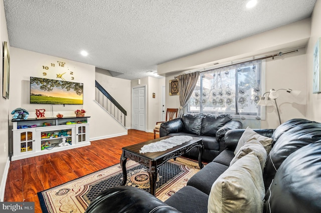 living room featuring hardwood / wood-style flooring and a textured ceiling