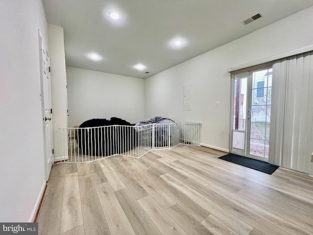 interior space with electric panel and light wood-type flooring