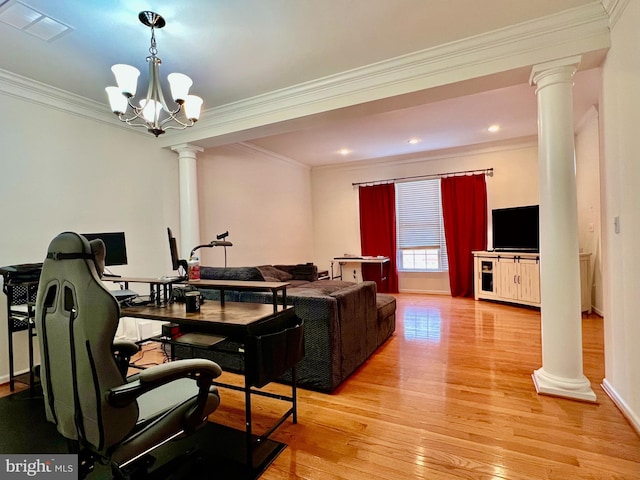 living room with an inviting chandelier, ornamental molding, light wood-type flooring, and ornate columns