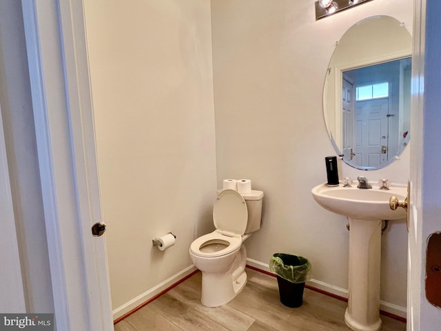 bathroom featuring hardwood / wood-style flooring, sink, and toilet