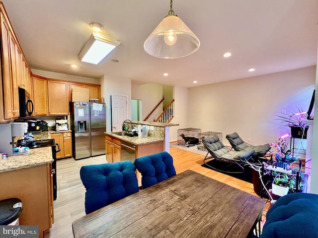 interior space with sink and light hardwood / wood-style flooring