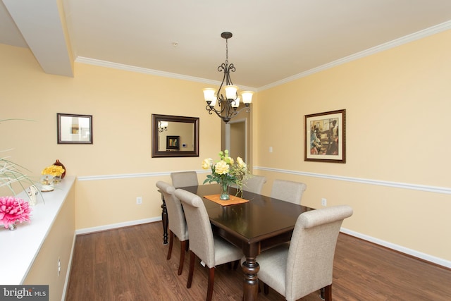 dining room featuring ornamental molding, dark wood-type flooring, and a notable chandelier