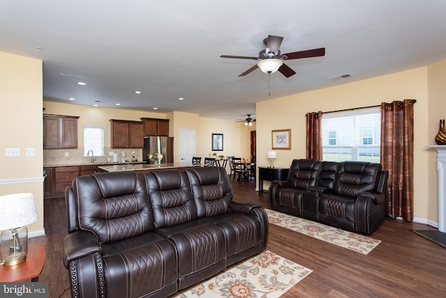 living room featuring sink, dark hardwood / wood-style floors, and ceiling fan