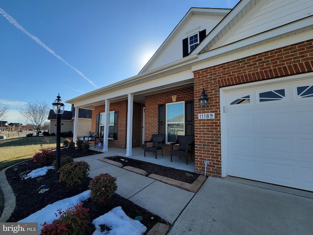 exterior space with a garage and covered porch