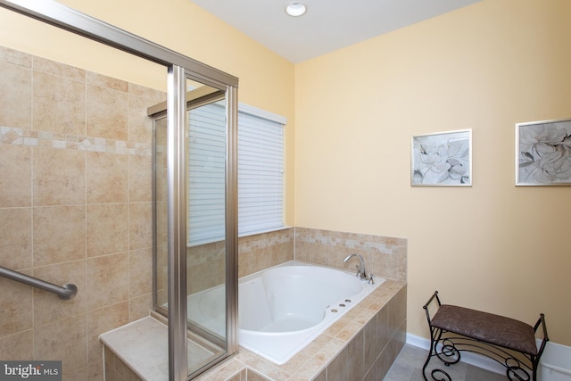 bathroom featuring separate shower and tub