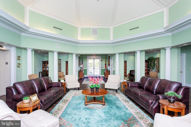 living room with ornate columns, crown molding, and a towering ceiling