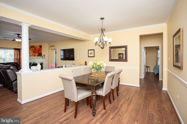 dining area featuring dark hardwood / wood-style flooring, ceiling fan with notable chandelier, decorative columns, and crown molding