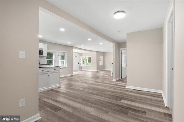 corridor with light hardwood / wood-style flooring