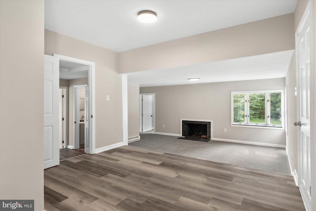 unfurnished living room with dark wood-type flooring