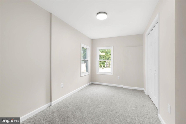 unfurnished bedroom with light colored carpet