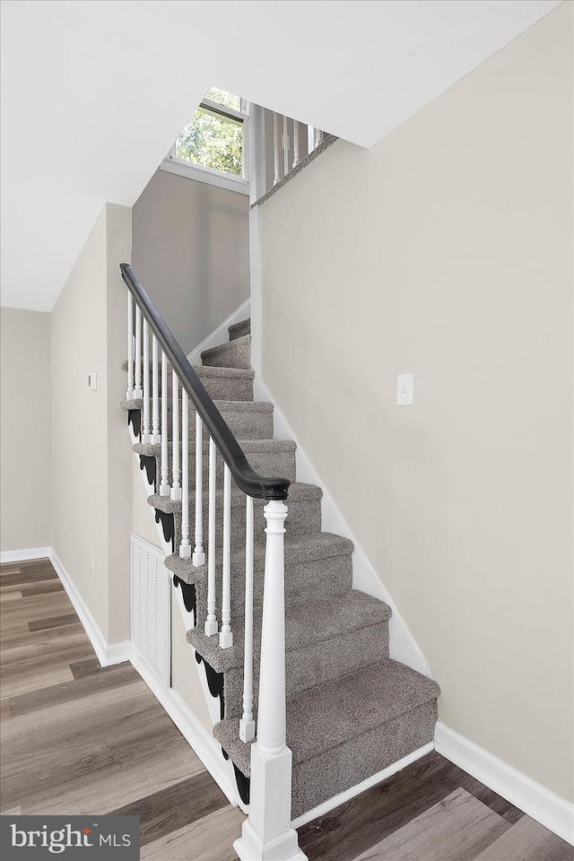 stairway featuring hardwood / wood-style floors