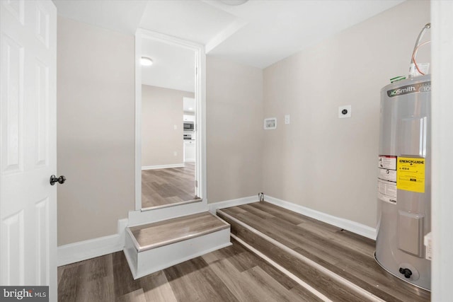 clothes washing area featuring dark hardwood / wood-style floors, electric water heater, and hookup for an electric dryer