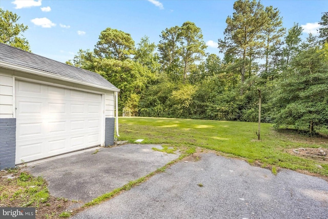 garage featuring a lawn