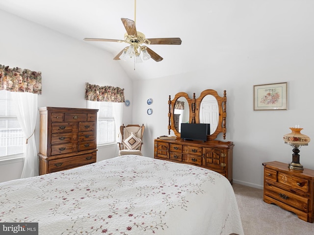 bedroom featuring lofted ceiling, light carpet, and ceiling fan