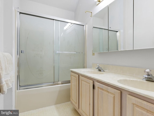 bathroom featuring enclosed tub / shower combo and vanity