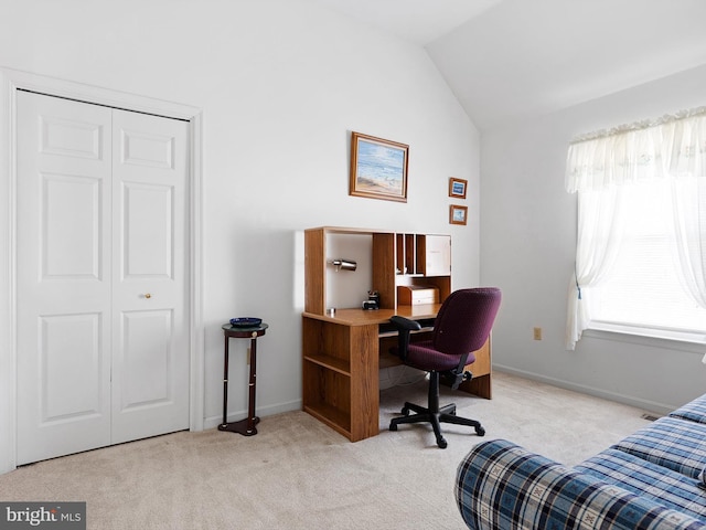 office space featuring light colored carpet and vaulted ceiling