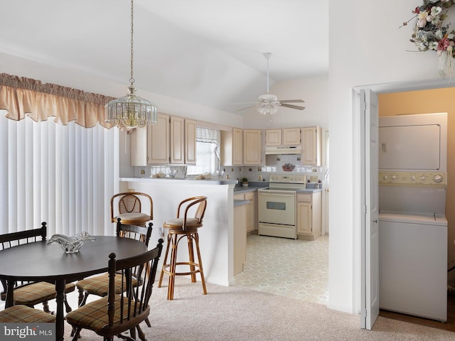 kitchen featuring ceiling fan, white range with electric cooktop, stacked washer / dryer, decorative light fixtures, and vaulted ceiling