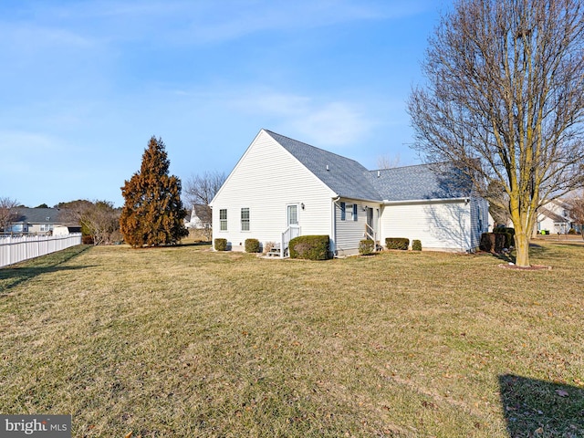 back of house featuring a yard