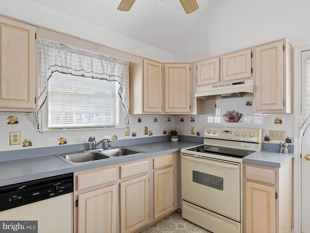 kitchen featuring vaulted ceiling, sink, light brown cabinetry, and white appliances