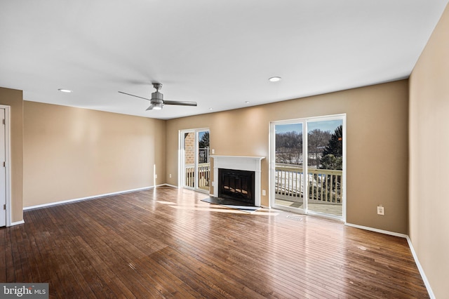 unfurnished living room featuring hardwood / wood-style flooring and ceiling fan