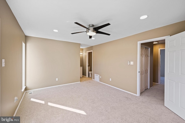 unfurnished bedroom with ceiling fan and light colored carpet