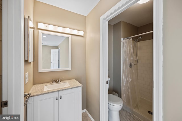 bathroom featuring vanity, tile patterned floors, toilet, and walk in shower