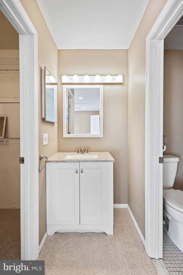 bathroom with vanity and toilet