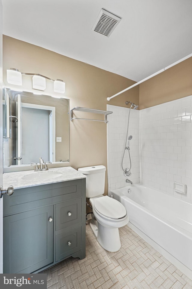 full bathroom with vanity, toilet, tiled shower / bath combo, and tile patterned flooring